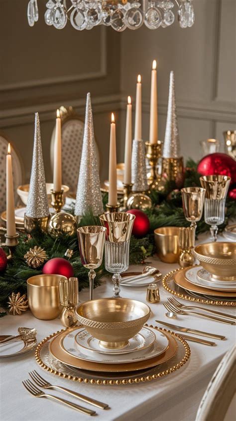 A Table Set For Christmas With Gold Dishes And Candles