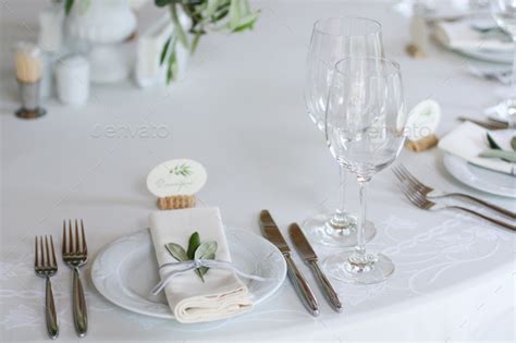 Stylish minimal table setting for the holiday with silver flatware and ...