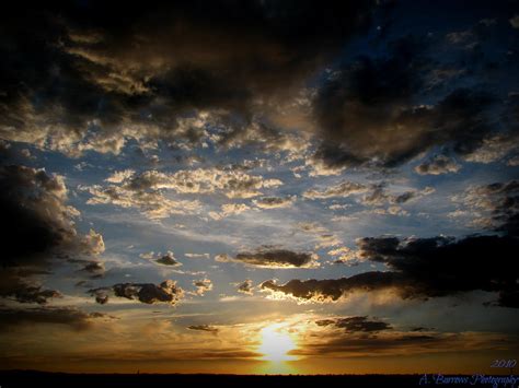 Partly Cloudy Skies At Sunset Photograph by Aaron Burrows