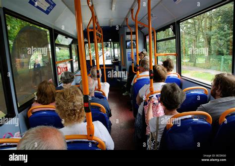 Interior Of Single Deck Bus Passengers Seated Inside Stock Photo