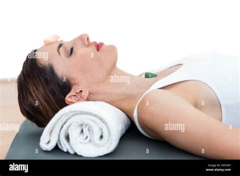 Relaxed Brunette Lying On Mat With Stones Stock Photo Alamy