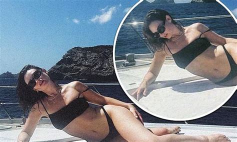 Lily James Shows Off Her Killer Figure In A Black Bikini As She Lounges On The Front Of A Yacht