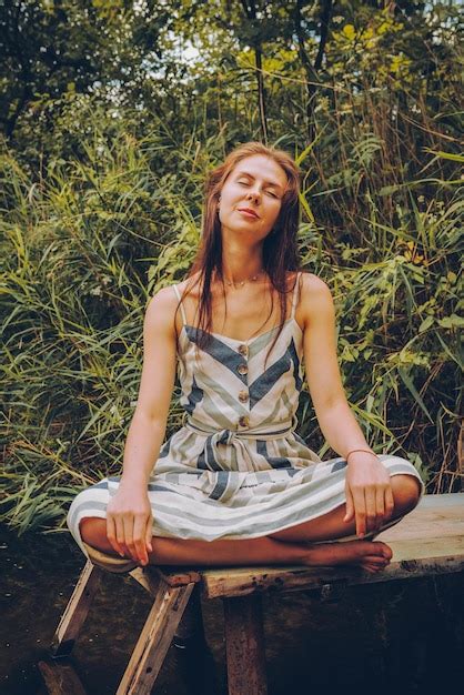 Premium Photo Woman Practicing Yoga On Pier By River Young Female