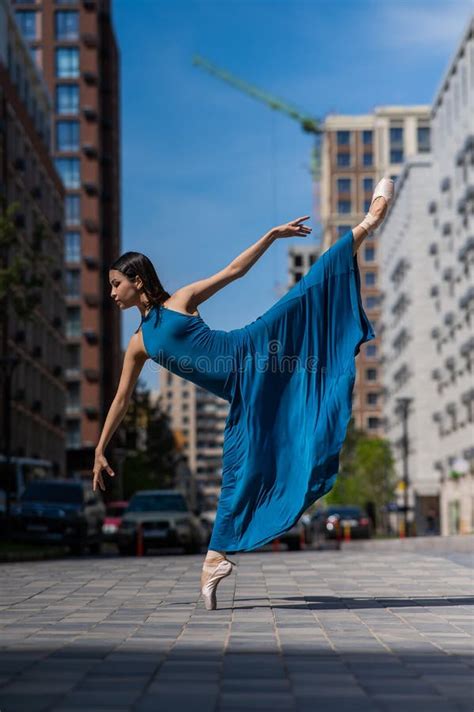 Beautiful Asian Ballerina In Blue Dress Posing In Splits Outdoors