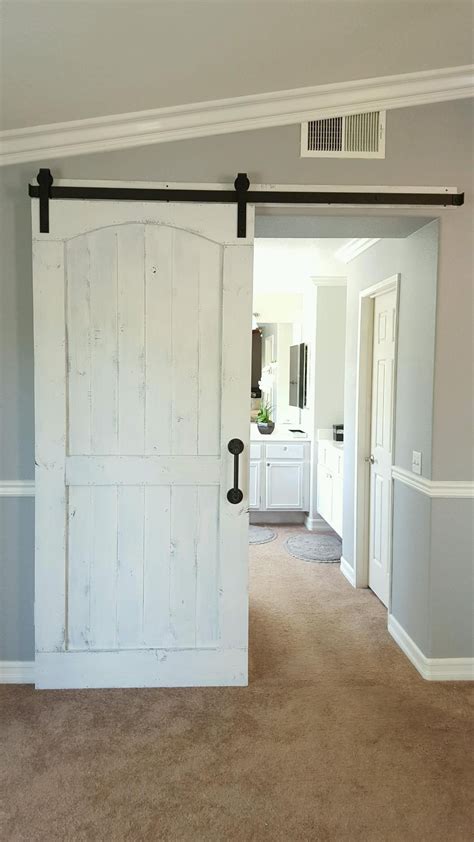 Distressed White Barn Door With Hardware For A Master Bedroom Bathroom