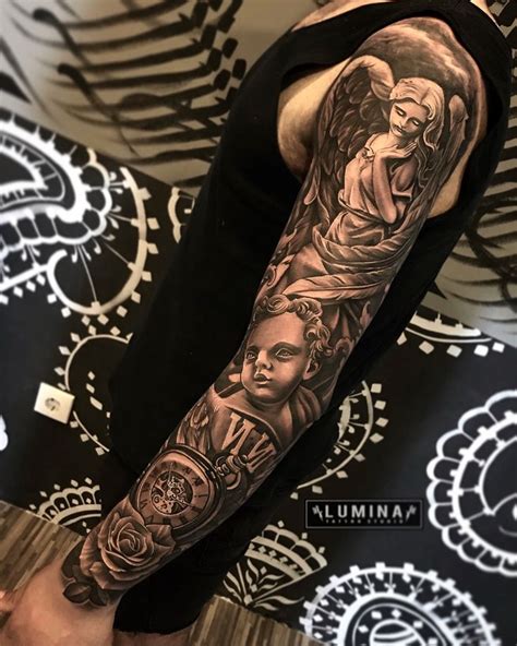 A Man With A Tattoo On His Arm That Has An Image Of Angels And Other Things