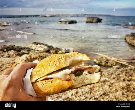 Person Holding Sandwich Beach Sky Beach Hi Res Stock Photography And