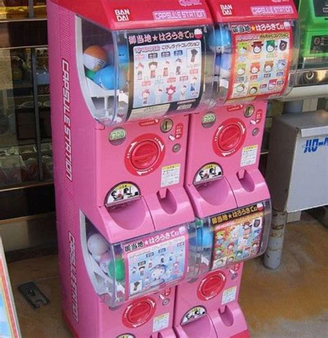 Two Pink Vending Machines Sitting Next To Each Other In Front Of A