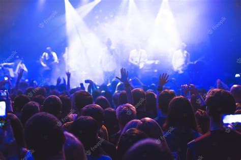 Premium Photo | The audience watching the concert on stage in night ...