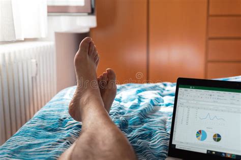 Man Works On Laptop In Bedroom Smart Working In Quarantine Stock Photo