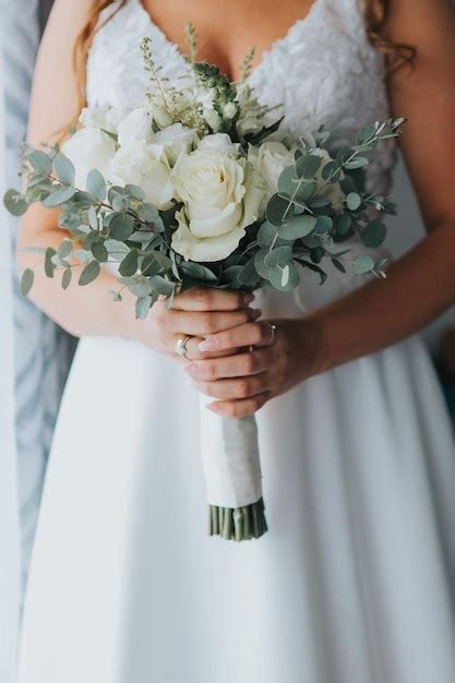 Premium Photo Vertical Shot Of A Bride In A Wedding Dress Holding A