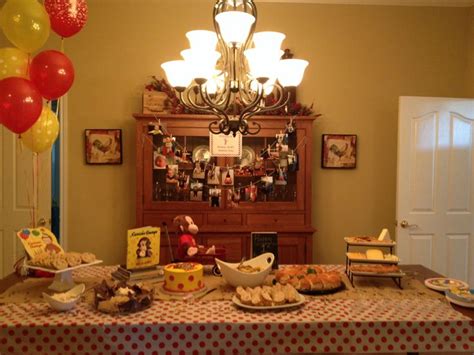 A Table Topped With Lots Of Food Next To A Chandelier Filled With Balloons