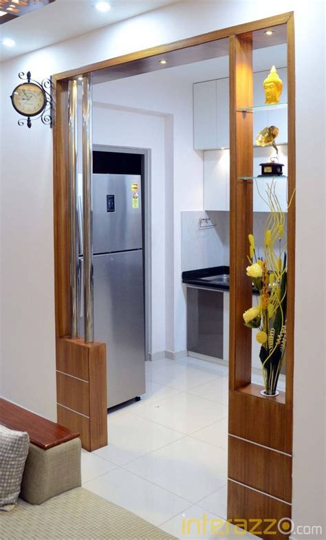 An Open Door Leading To A Kitchen And Living Room With A Clock On The Wall