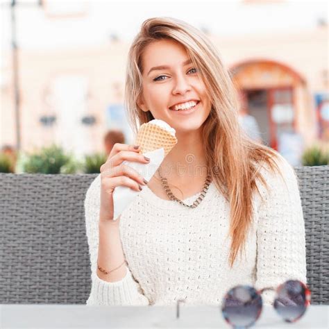 Smiling Girl Eating An Ice Cream Scoop In A Waffle Cone Stock Image