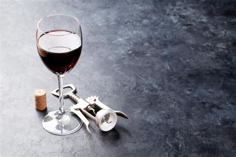 Premium Photo Red Wine Glass And Corkscrew