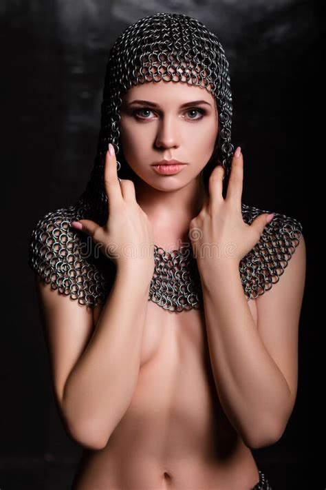 Portrait Of A Beautiful Naked Woman In A Chain Mail Skirt And A Chain Mail Hood Posing Covering