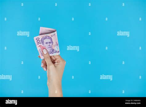 Cash Money Female Hands Holding Ukrainian Banknotes On Blue Background