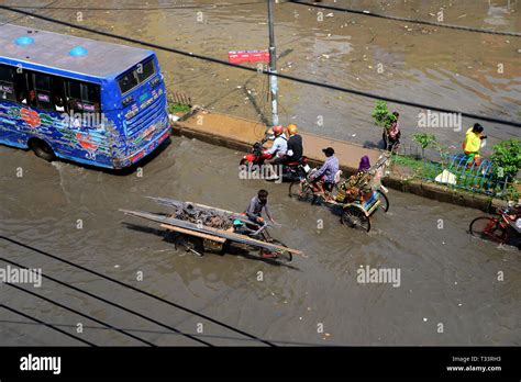 Vehicles And Rickshaws Try Driving With Passengers Through The