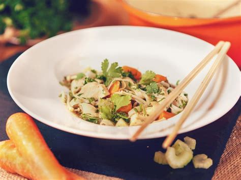 A White Plate Topped With Salad And Chopsticks