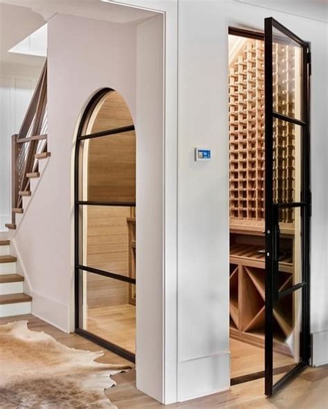 A Wine Cellar In The Middle Of A Room With Stairs Leading Up To It S