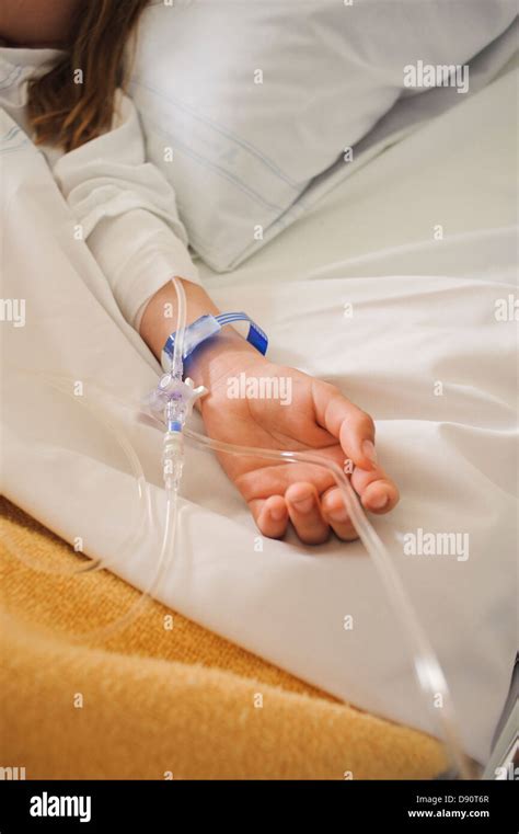 Girl Lying On Hospital Bed With IV Drip On Arm Stock Photo Alamy