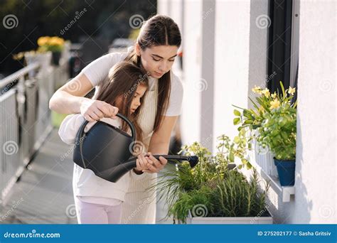 Mom Watering Plant with Her Adorable Little Daughter. Happy Family ...