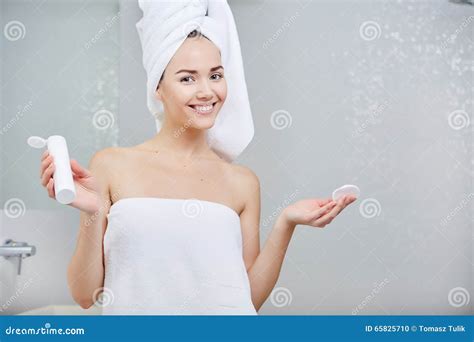 Beautiful Young Woman Applying Facial Moisturizing Cream Skincare