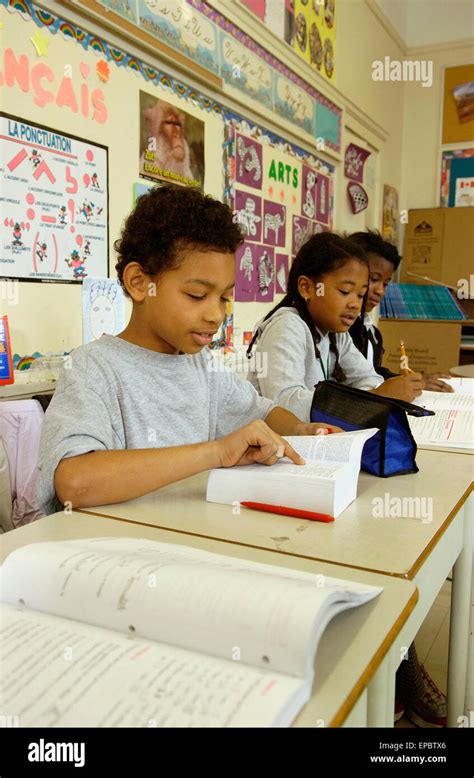 Grade 5 students working at their desks in the classroom Stock Photo - Alamy