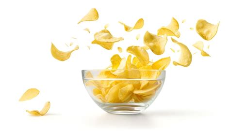 Potato Chips Falling Into Glass Bowl Isolated On White Background With