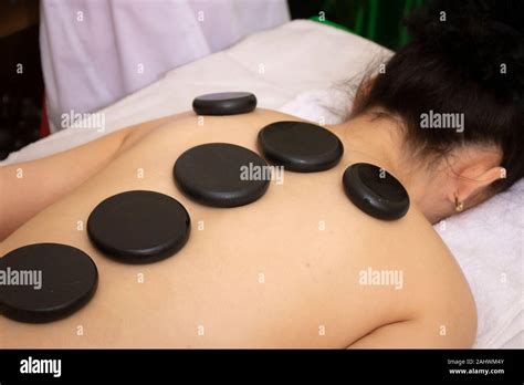 Massage With Hot Basalt Stones Beautiful Deep Charming Light Stock Photo Alamy