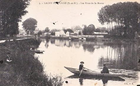 An Old Black And White Photo Of Two People In A Boat On A River With Ducks