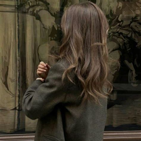 A Woman Standing In Front Of A Large Painting