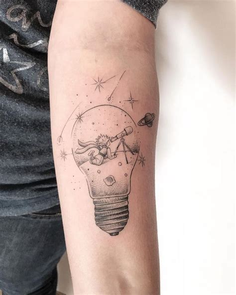 A Person With A Tattoo On Their Arm Has A Light Bulb In The Shape Of A