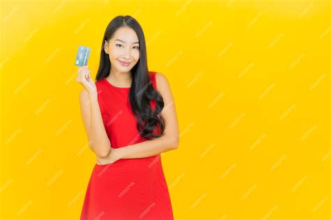 Premium Photo Portrait Beautiful Young Asian Woman Smile With Credit Card On Yellow Wall