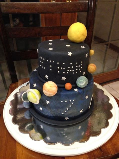 a cake with planets on it sitting on top of a table