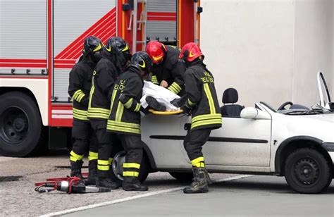 Firefighters Relieve An Injured After Car Accident Stock Image