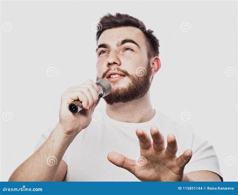 Bearded Man Singing To The Microphone Emotional Portrait Of An Attractive Guy With A Beard On A