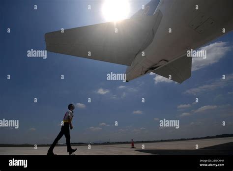 A Chinese Ground Crew Member Checks A Jet Plane Of China Southern