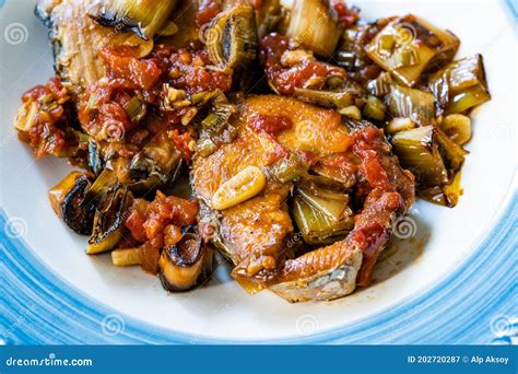 Bonito Fish Pieces With Tomato Sauce And Leek In Plate Baked In Oven