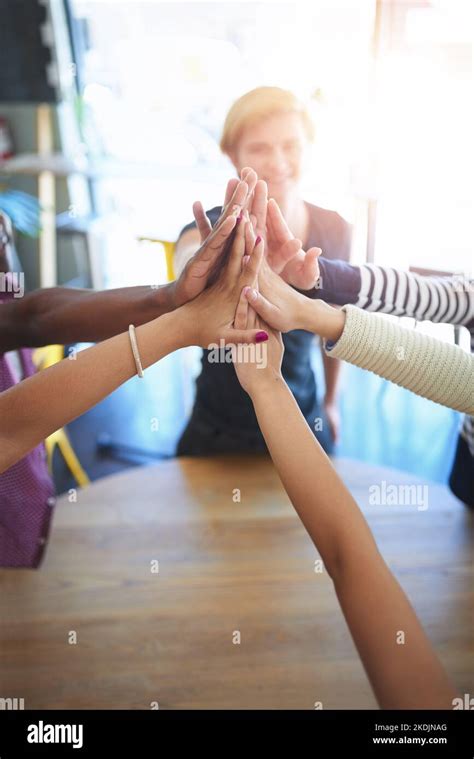 Live While Youre Young A Group Of Happy Friends High Fiving Each Other