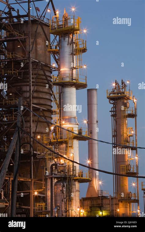 Oil And Gas Refinery With Towers Illuminated At Dusk Montreal East