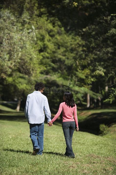 Couple Holding Hands Couple Holding Hands Walking And Talking In Park