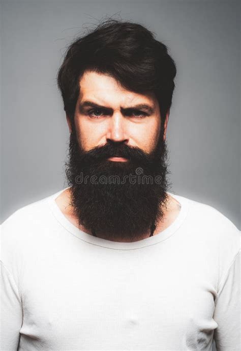 Portrait Of Confident Serious Man Has Beard And Mustache Looks Seriously Isolated Thinking