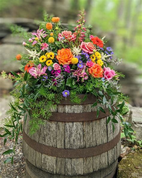 Rustic Wooden Barrel Filled With Colorful Wedding Flowers