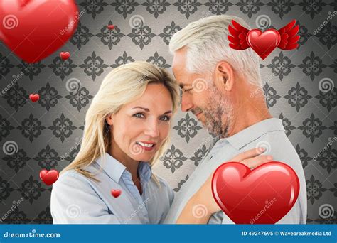 Composite Image Of Happy Couple Standing And Smiling At Camera Stock