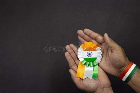 Hand Holding Indian Flag Badge On Black Background Tricolor Saffron