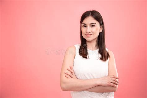 Portrait Of A Young Woman On An Isolated Pink Background Stock Photo