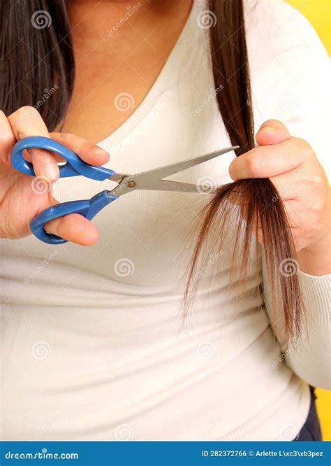 40 Year Old Latina Woman With Very Long Straight Hair Wants To Cut Her Hair With Scissors Stock