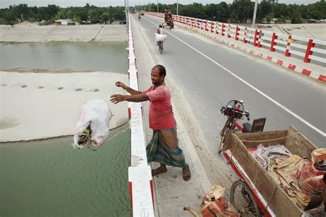 Man Throwing Garbage In The River