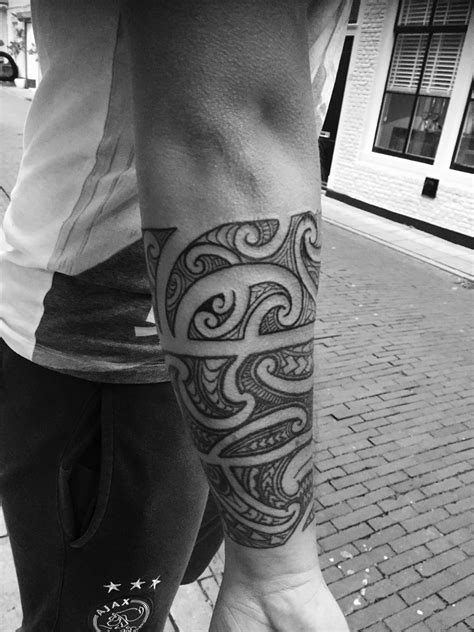 A Man With A Tattoo On His Arm